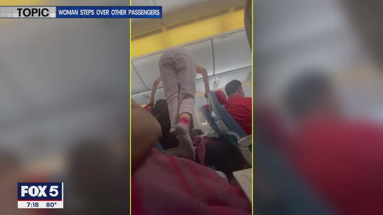 Woman climbs over passengers on airplane to get to window seat