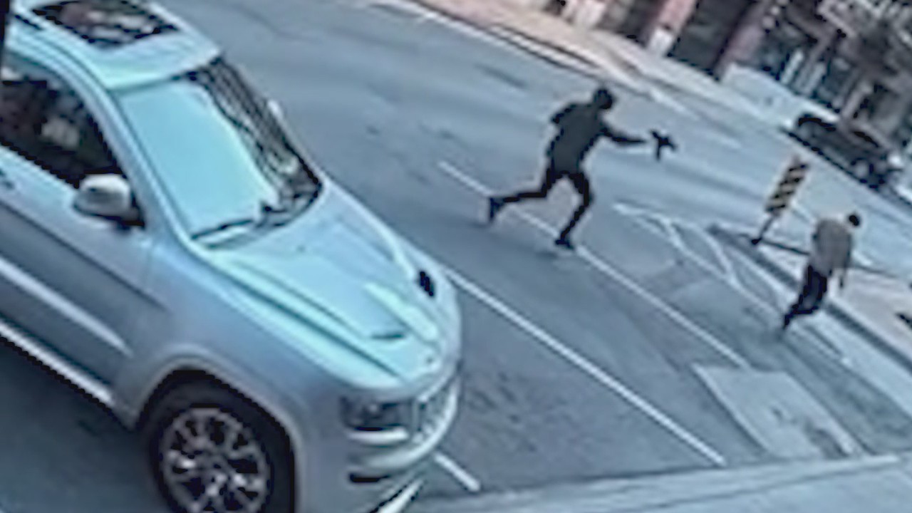 Surveillance video shows gunman chasing victim in Chicago
