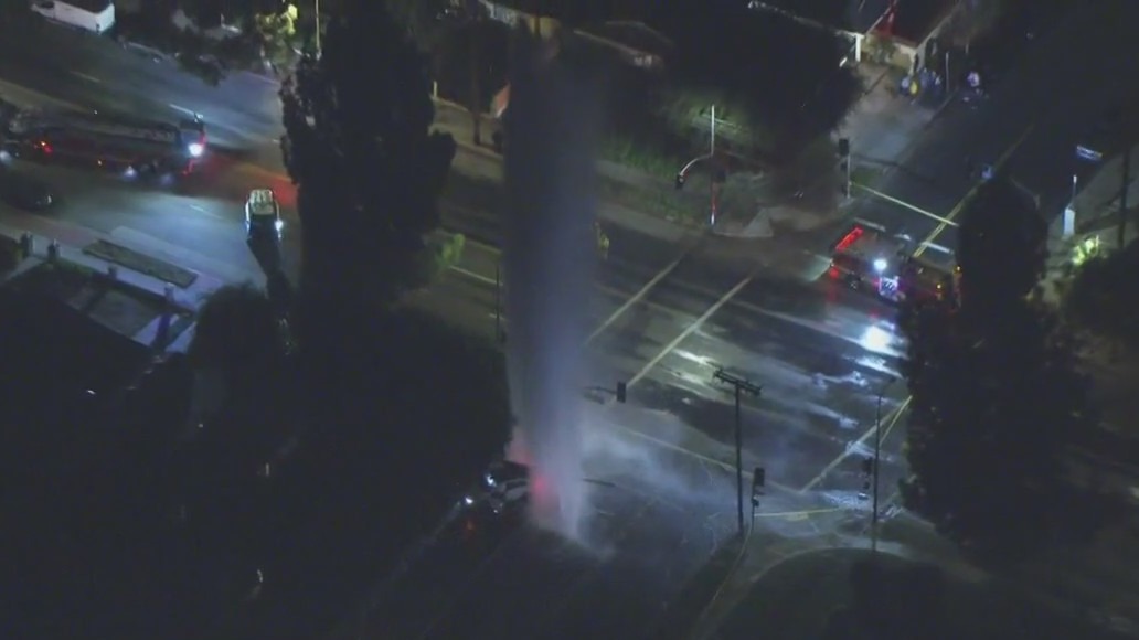 Car shears through hydrant, brings down wires