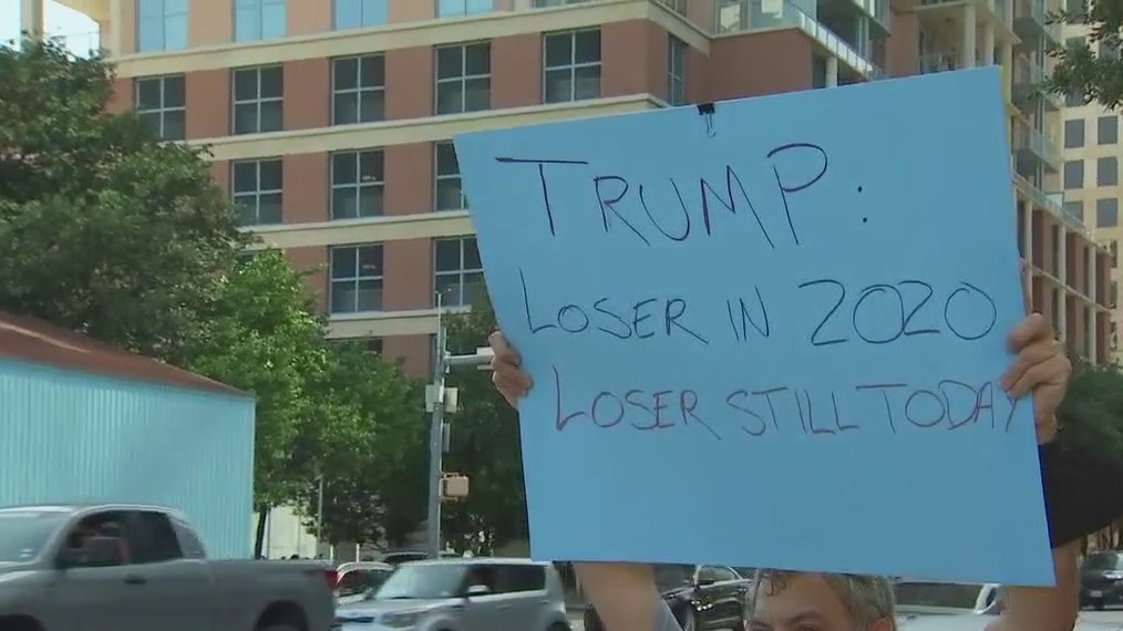 Protestors gather outside Austin Convention Center during Trump's visit