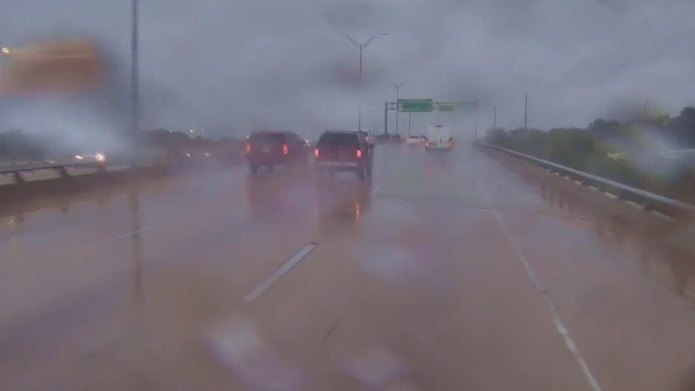 Look at road conditions as rain falls in Austin