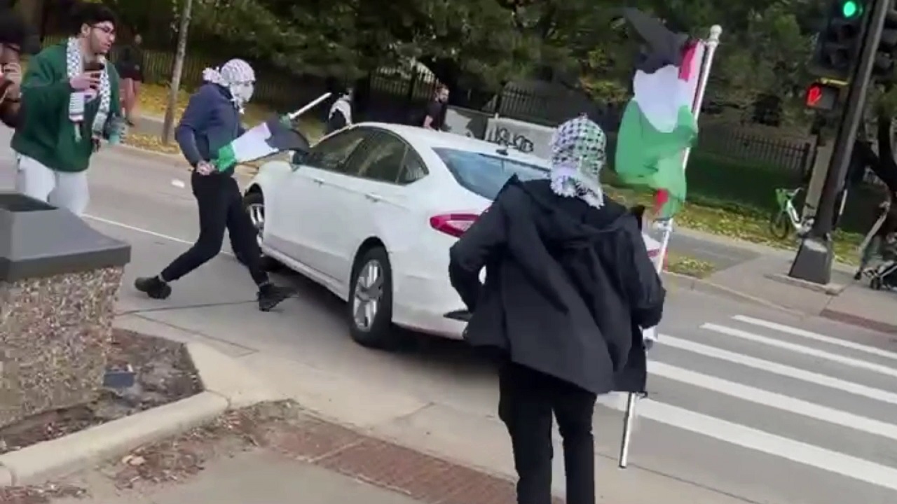 Protesters face off with driver