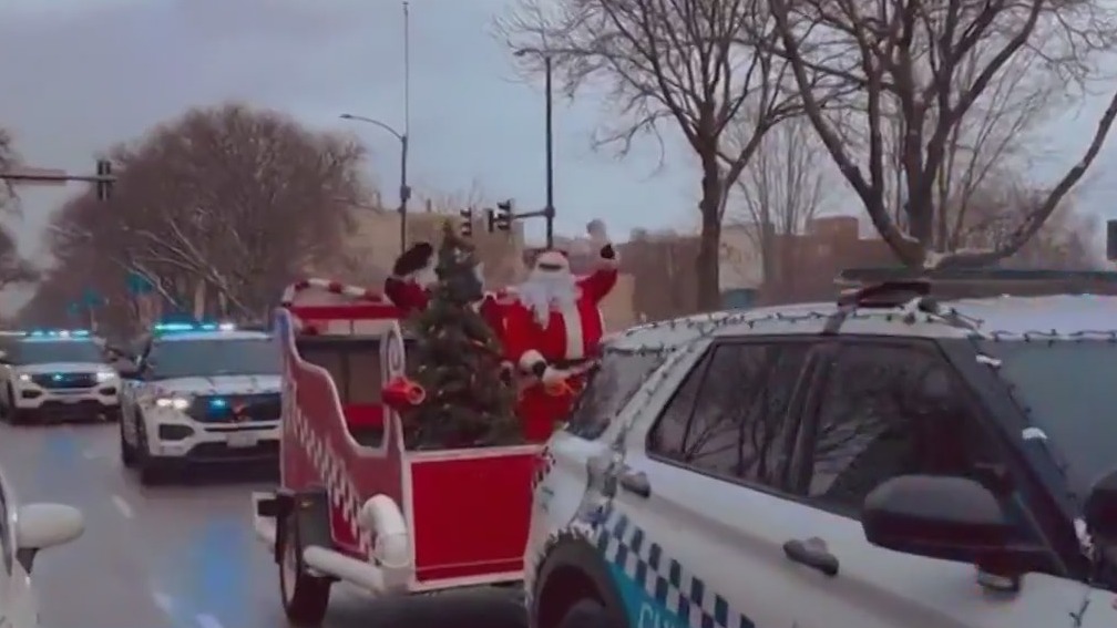 Chicago police escort Santa and Mrs. Claus around the city