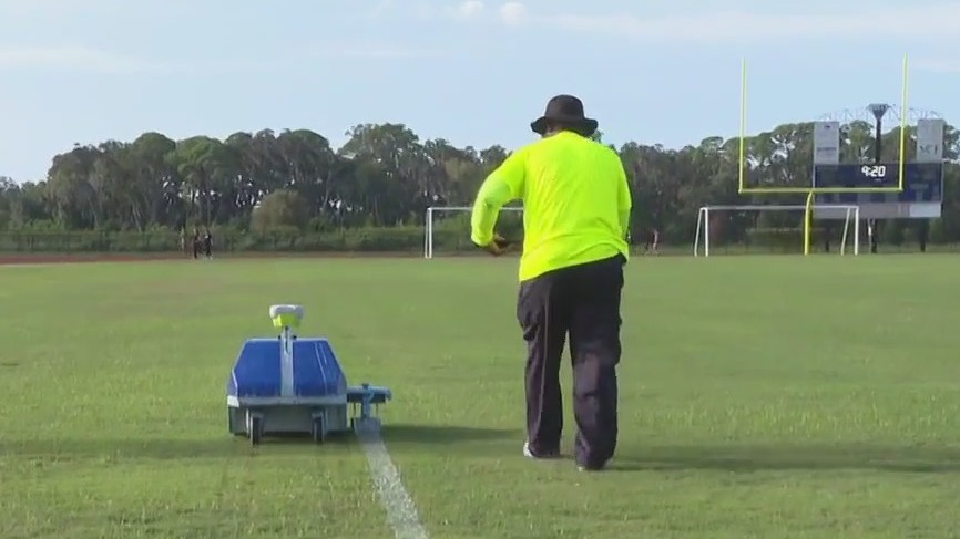 Robot helps paint high school football field
