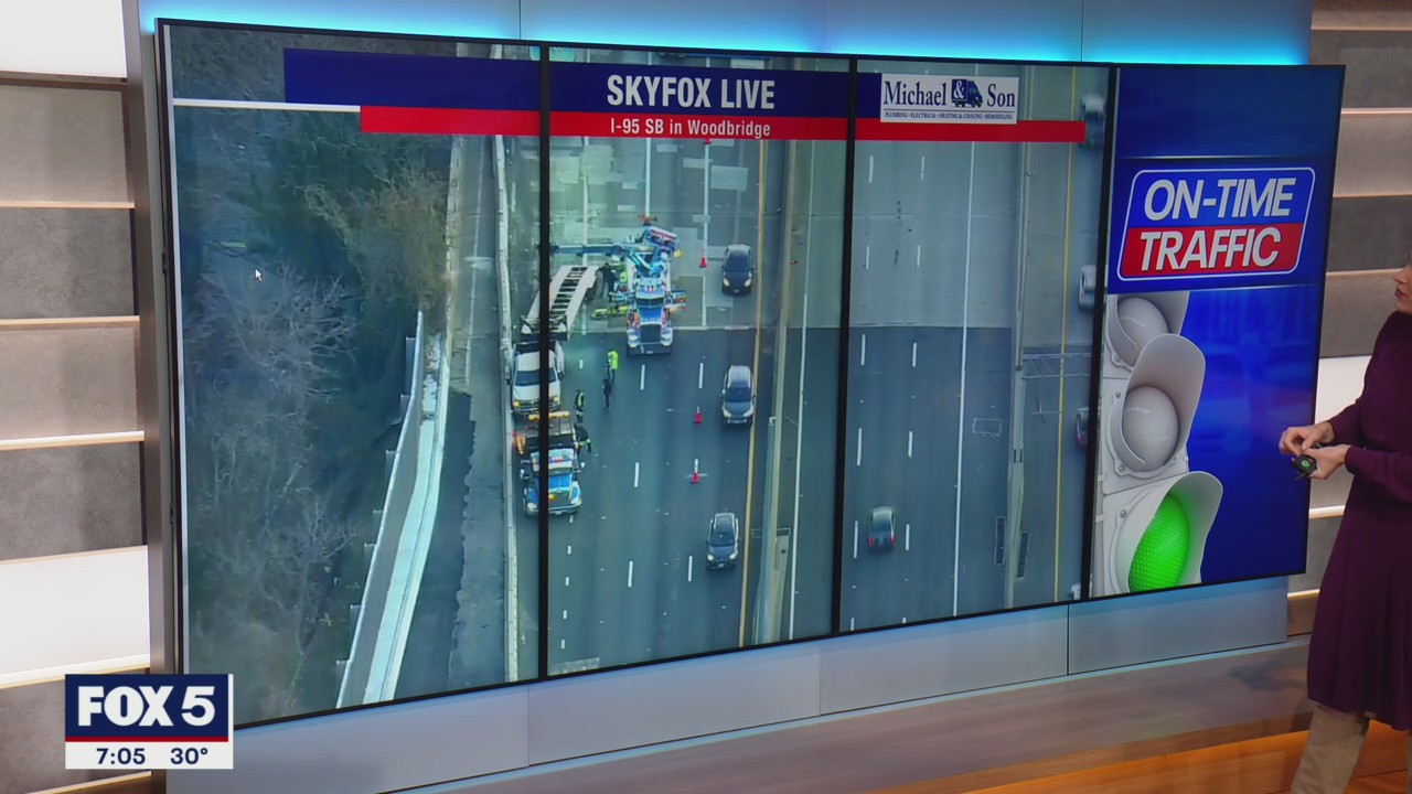 Crane called to remove overturned vehicle that flipped over concrete barrier in Woodbridge