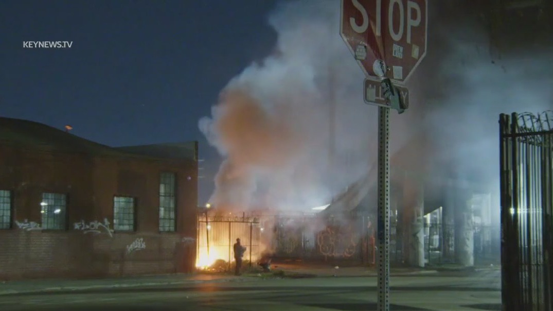 Trash fire sparks near 10 freeway in DTLA