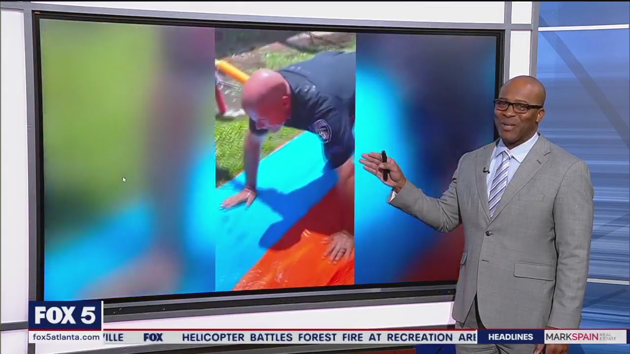 Police officer joins Slip N Slide fun