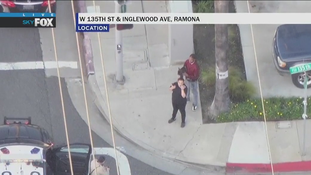 Two people and dog get out of car during Inglewood pursuit
