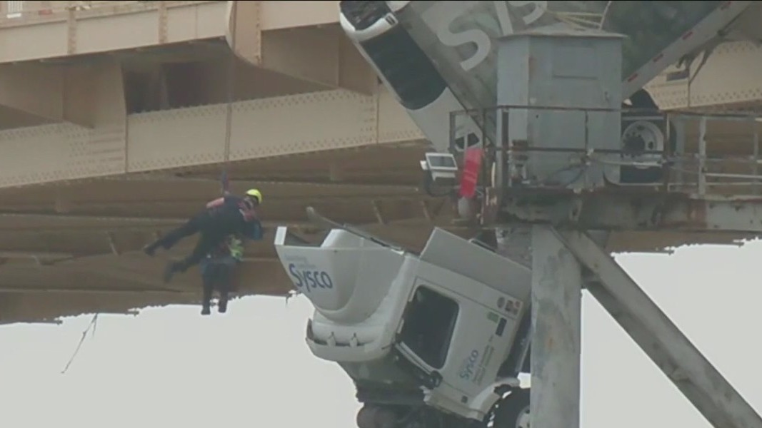 Driver rescued after semi-truck dangles over Ohio River
