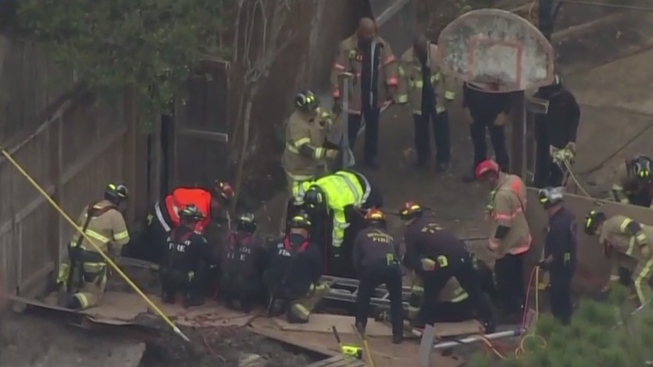 Houston Fire Departments attempts to rescue man trapped in a trench