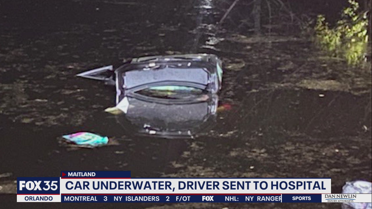 Driver sent to hospital after car submerged in pond