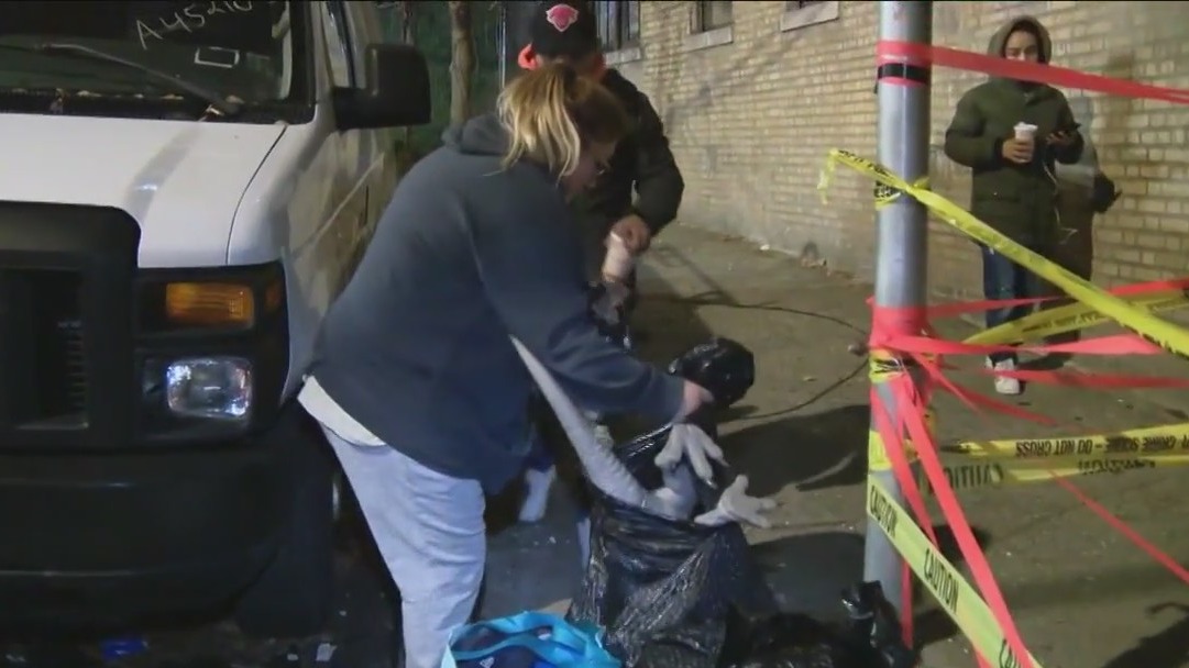 Residents take some belongings from Bronx building