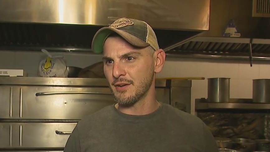 Pizza shop hero returns to work
