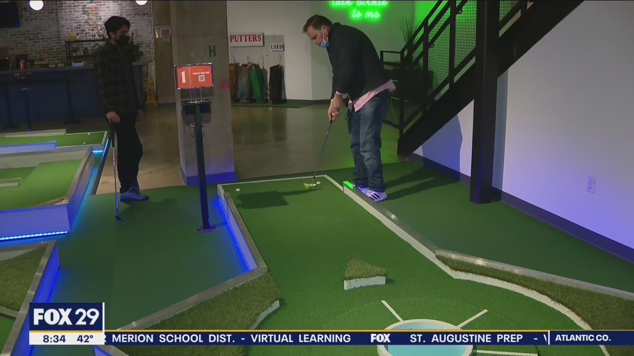Hank tests his mini-golf skills at Libertee Grounds