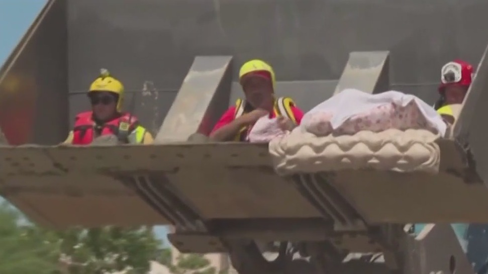 Couple rescued by bulldozer after tropical storm hits