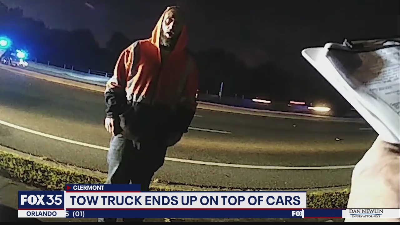 Tow truck ends up on top of cars