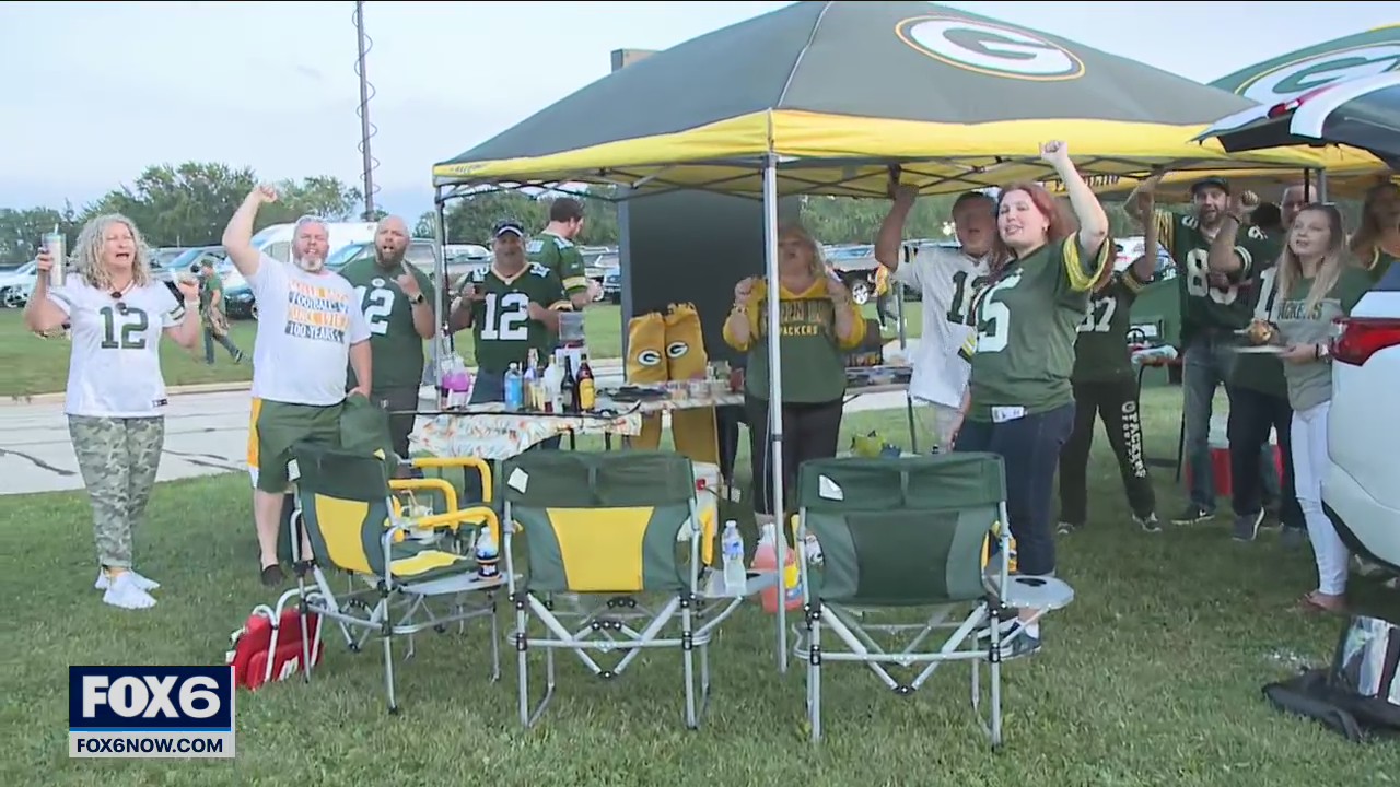 Fans celebrate the home opener at Lambeau
