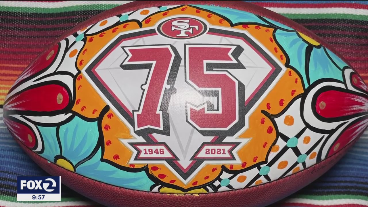 Latinx artist hand-painting footballs