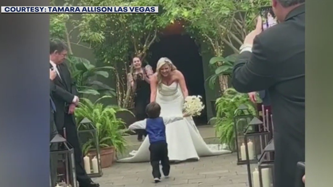 Toddler reacts to seeing mom walking down aisle