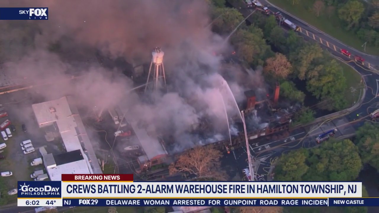 Crews battling warehouse fire in Hamilton Township