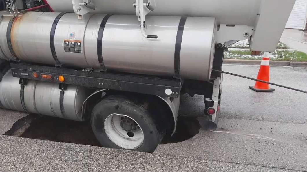 Truck falls into sinkhole in West Bend