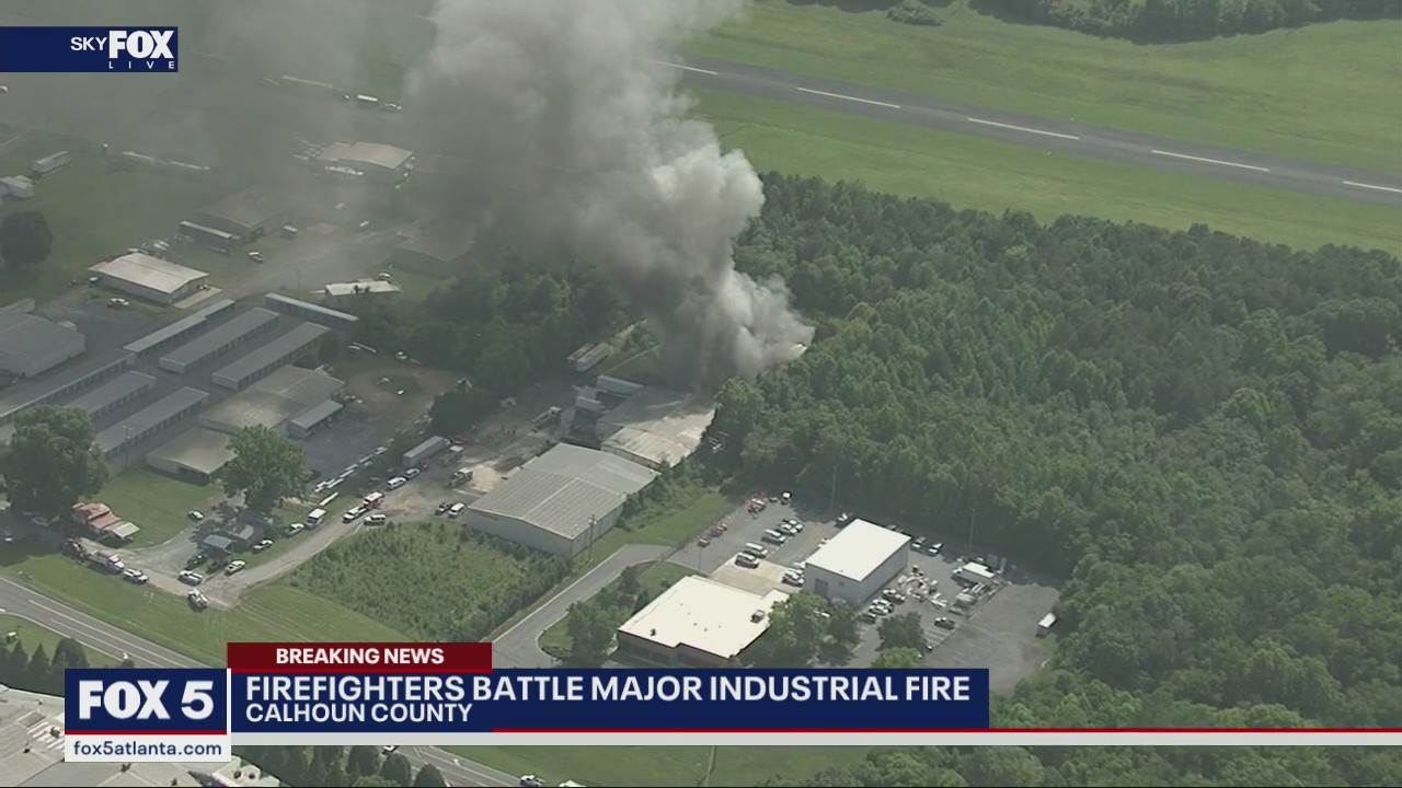 Firefighters work to combat large warehouse fire in Calhoun
