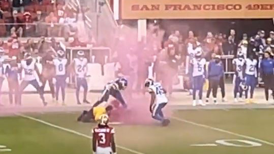 Los Angeles Rams LB Bobby Wagner runs over protester