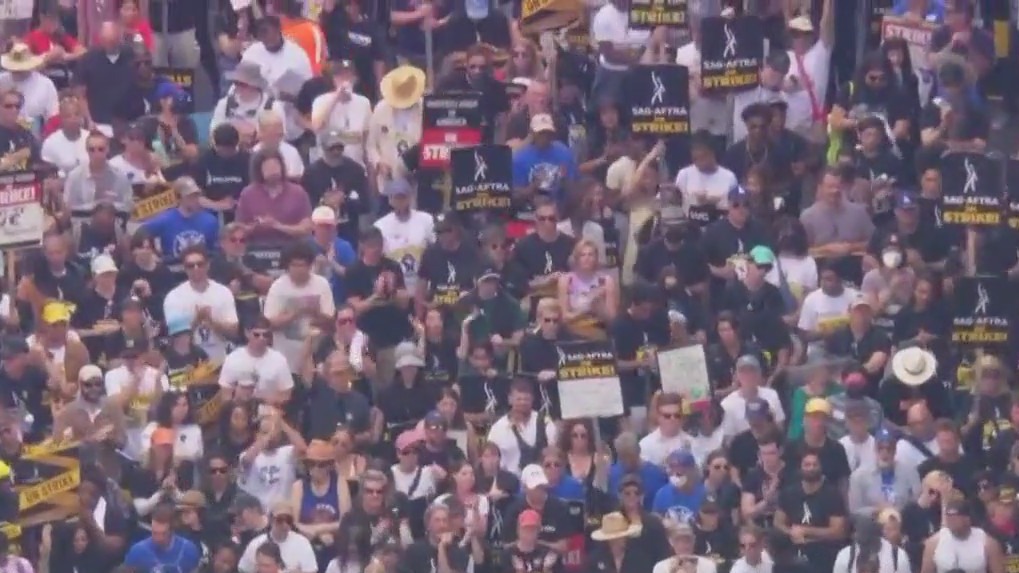 Entertainment strikers march in Hollywood