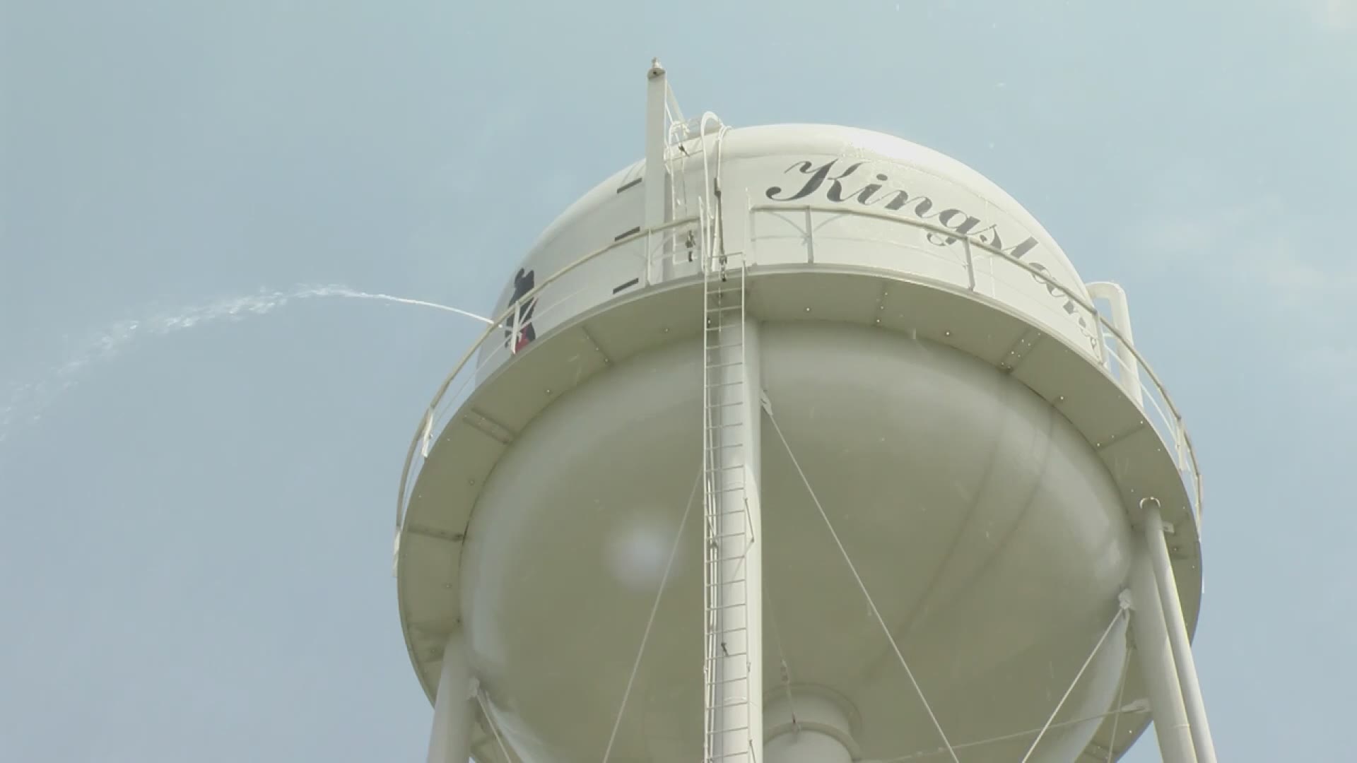 Arkansas water tower featuring silhouette of Johnny Cash hit with bullet