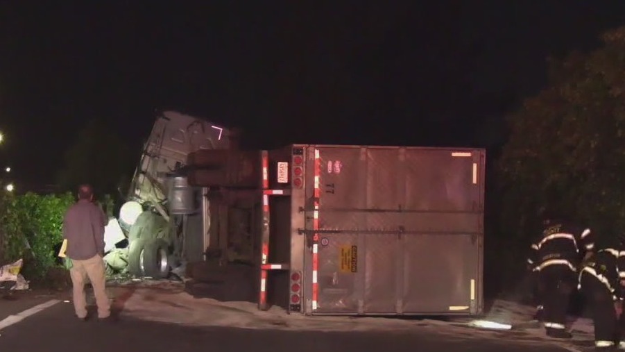 Big rig overturns on freeway ramp