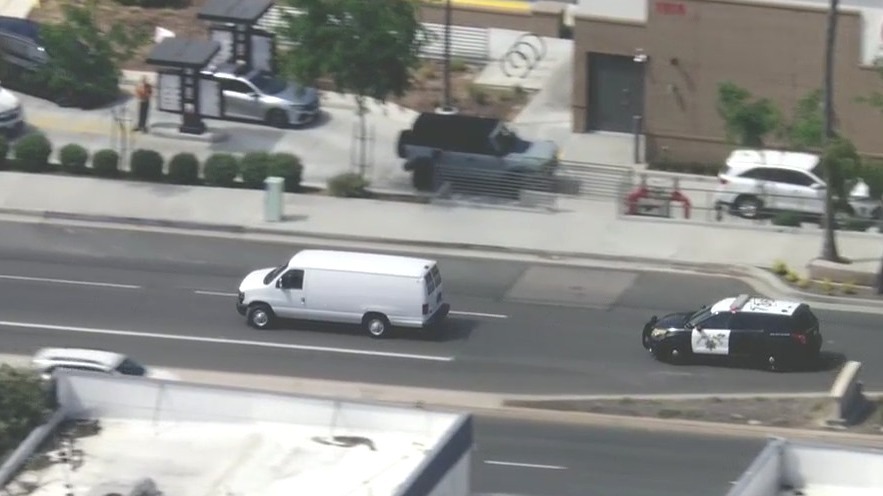 White van drags police on slow chase